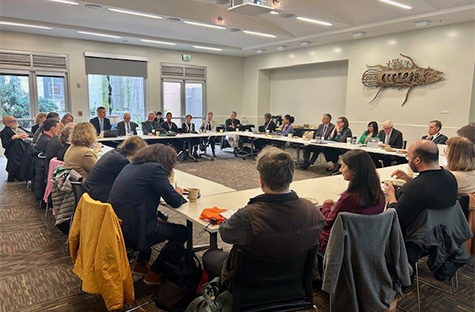 Image of a table view at an academic event, showcasing the setup and participants.