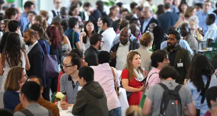 Image of an academic event, showcasing participants engaged in discussions.
