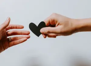 Image of hands and a heart, showcasing the importance of giving.