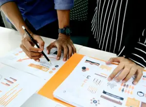 Image of researchers examining a report, highlighting excellence.